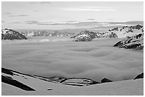 Peaks emerging from clouds at sunset. Kenai Fjords National Park, Alaska, USA. (black and white)