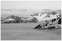 Midnight sunset on peaks above clouds. Kenai Fjords National Park, Alaska, USA. (black and white)