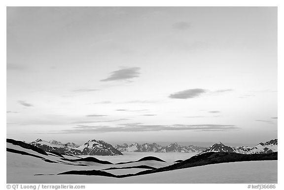 Pastel sky, mountain ranges and sea of clouds at dusk. Kenai Fjords National Park, Alaska, USA.