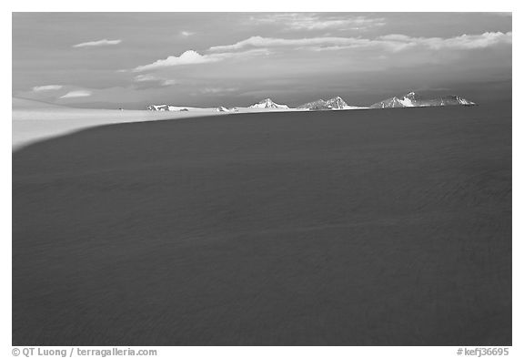 Distant mountains emerging from shadows over the Harding field. Kenai Fjords National Park, Alaska, USA.