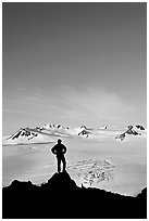 Hiker standing on overlook above Harding icefield. Kenai Fjords National Park, Alaska, USA. (black and white)