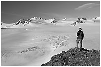 Man looking at the Harding ice field, early morning. Kenai Fjords National Park, Alaska, USA. (black and white)