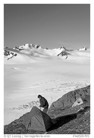 Camper exiting tent above the Harding ice field. Kenai Fjords National Park (black and white)