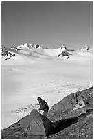 Camper exiting tent above the Harding ice field. Kenai Fjords National Park ( black and white)