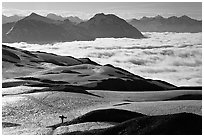 Mountains with snowboarder hiking down on snow-covered trail. Kenai Fjords National Park, Alaska, USA. (black and white)