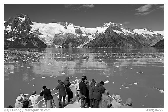 People looking at glaciers as boat crosses ice-chocked waters, Northwestern Fjord. Kenai Fjords National Park (black and white)
