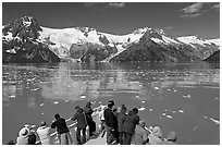 People looking at glaciers as boat crosses ice-chocked waters, Northwestern Fjord. Kenai Fjords National Park ( black and white)