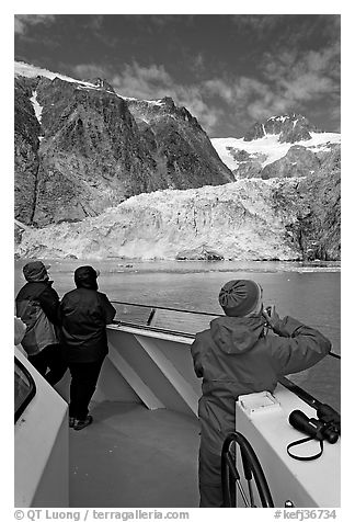 Passengers looking at Northwestern glacier from the deck of tour boat. Kenai Fjords National Park (black and white)