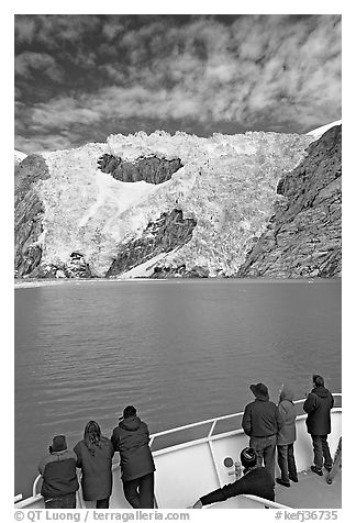 People watch  Northwestern glacier from deck of boat, Northwestern Lagoon. Kenai Fjords National Park, Alaska, USA.