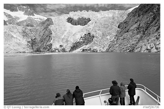 People looking at Northwestern glacier from deck of boat, Northwestern Fjord. Kenai Fjords National Park, Alaska, USA.