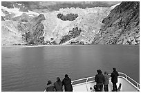 People looking at Northwestern glacier from deck of boat, Northwestern Fjord. Kenai Fjords National Park, Alaska, USA. (black and white)