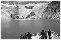 People looking at Northwestern glacier from deck of boat, Northwestern Fjord. Kenai Fjords National Park, Alaska, USA. (black and white)