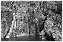 Waterfalls streaming into the ocean, Cataract Cove, Northwestern Fjord. Kenai Fjords National Park, Alaska, USA. (black and white)