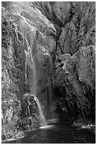 Waterfall streaming into Cataract Cove, Northwestern Fjord. Kenai Fjords National Park, Alaska, USA. (black and white)