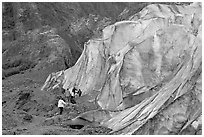 Family exploring at the base of Exit Glacier. Kenai Fjords National Park, Alaska, USA. (black and white)