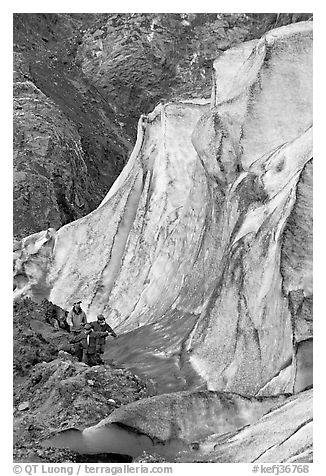 Man and children hiking on moraine at the base of Exit Glacier. Kenai Fjords National Park, Alaska, USA.