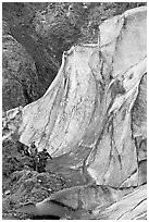 Man and children hiking on moraine at the base of Exit Glacier. Kenai Fjords National Park, Alaska, USA. (black and white)