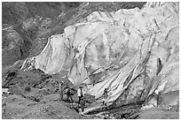 Family hiking on moraine at the base of Exit Glacier. Kenai Fjords National Park, Alaska, USA. (black and white)