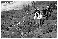 Women carrying infants on trail. Kenai Fjords National Park, Alaska, USA. (black and white)