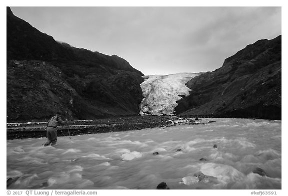 Hiker crosses glacial stream, Exit Glacier. Kenai Fjords National Park (black and white)