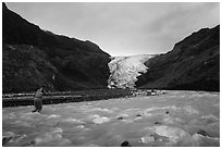 Hiker crosses glacial stream, Exit Glacier. Kenai Fjords National Park ( black and white)