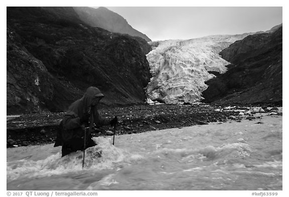 Hiker traverses glacial stream, Exit Glacier. Kenai Fjords National Park (black and white)