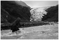 Hiker traverses glacial stream, Exit Glacier. Kenai Fjords National Park ( black and white)