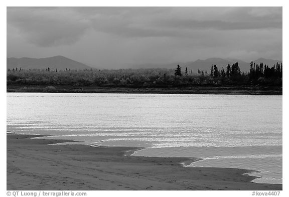 Sand bar shore, bright river and Baird mountains, evening. Kobuk Valley National Park, Alaska, USA.