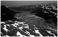 Aerial view of Tikakila River valley under dark clouds. Lake Clark National Park, Alaska, USA. (black and white)