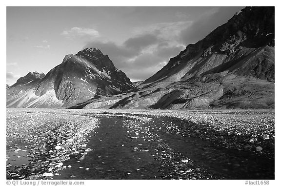 Wide gravel river bar below the Telaquana Mountains, sunset. Lake Clark National Park, Alaska, USA.