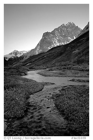 Stream on plain  below the Telaquana Mountains, late afternoon. Lake Clark National Park, Alaska, USA.