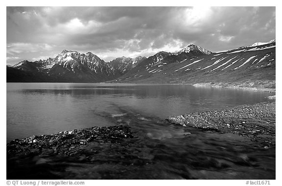 Stream flowing into Turquoise Lake, sunset. Lake Clark National Park, Alaska, USA.