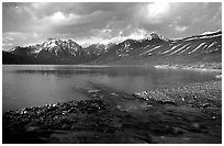 Stream flowing into Turquoise Lake, sunset. Lake Clark National Park, Alaska, USA. (black and white)
