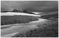 Snow nevesand mountains under dark storm clouds. Lake Clark National Park, Alaska, USA. (black and white)