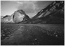 Stream on wide gravel bar and peaks at sunset. Lake Clark National Park, Alaska, USA. (black and white)