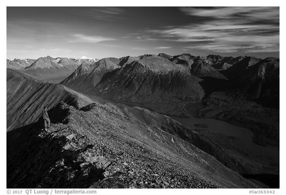 Visitor looking, summit of Tanalian Mountain and Kontrashibuna Lake. Lake Clark National Park (black and white)