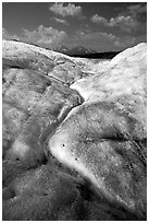 Ice, glacial creek on Root glacier, and mountains. Wrangell-St Elias National Park, Alaska, USA. (black and white)