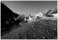 Morainic debris on Root glacier with Wrangell mountains in the background, late afternoon. Wrangell-St Elias National Park, Alaska, USA. (black and white)