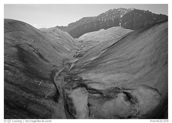 Root Glacier, glacial stream, and mountains at dusk. Wrangell-St Elias National Park, Alaska, USA.