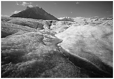 Stream running on surface of Root Glacier and Mt Donoho. Wrangell-St Elias National Park, Alaska, USA. (black and white)