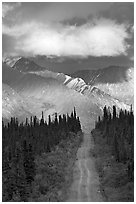 Road leading to mountains and clould lit by sunset light. Wrangell-St Elias National Park ( black and white)