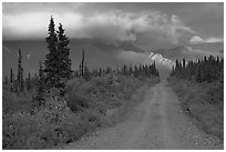 Nabena road at sunset with last light on mountains. Wrangell-St Elias National Park, Alaska, USA. (black and white)