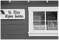 Mountain guide office with interesting signs. Wrangell-St Elias National Park, Alaska, USA. (black and white)