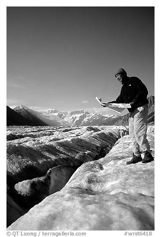 Hiker checks map on Root Glacier. Wrangell-St Elias National Park (black and white)