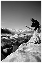 Hiker checks map on Root Glacier. Wrangell-St Elias National Park, Alaska, USA. (black and white)