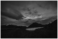 Root Glacier and Donoho Peak at night with stars, clouds, and northern lights. Wrangell-St Elias National Park ( black and white)