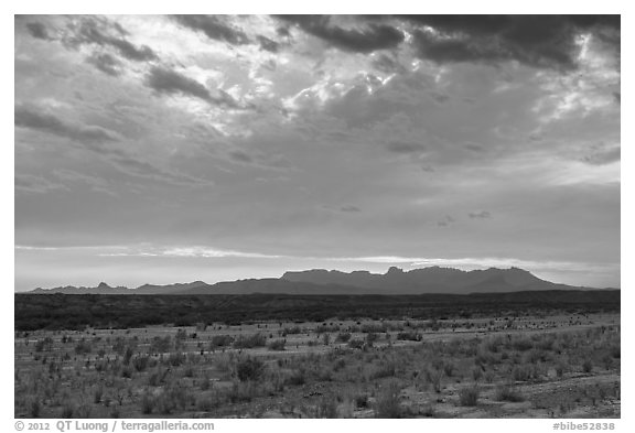Dry riverbed, distant Chisos Mountains, and clouds. Big Bend National Park (black and white)