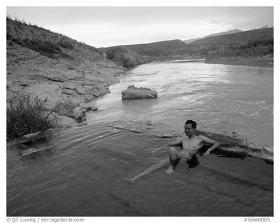 Visitor relaxes in hot springs next to Rio Grande. Big Bend National Park (black and white)