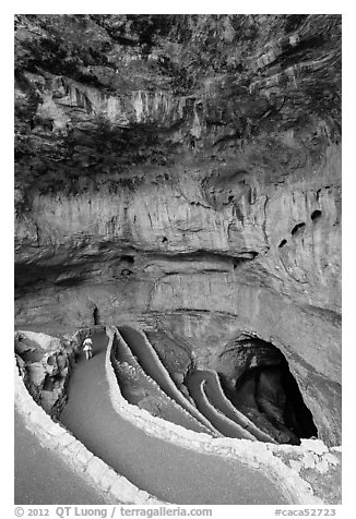 Tourist walking down natural entrance. Carlsbad Caverns National Park (black and white)