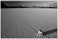 Tracks, moving rock on the Racetrack, late afternoon. Death Valley National Park, California, USA. (black and white)